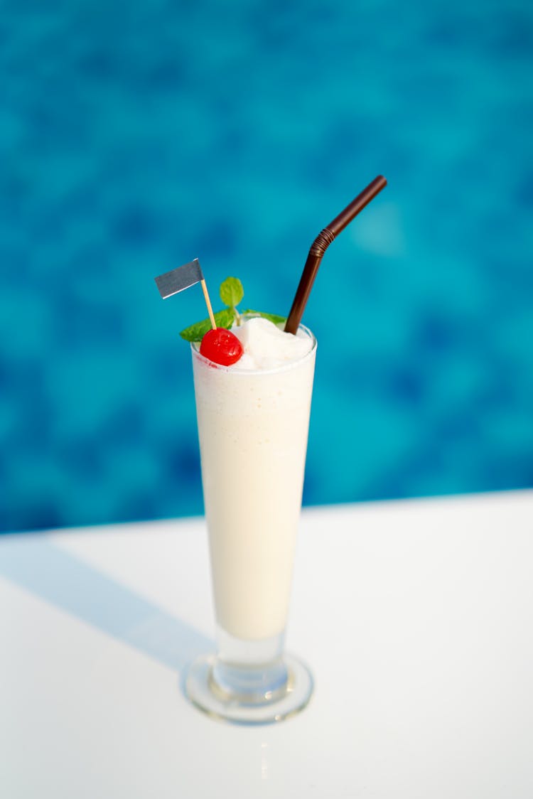 White Cocktail With A Cherry On Top 