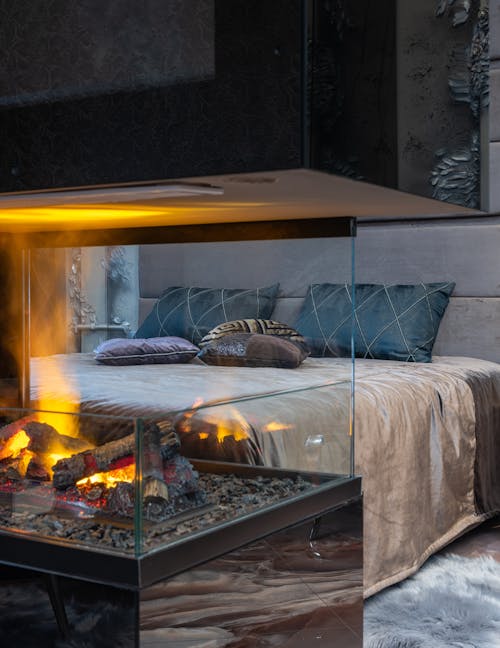 Free Cozy bedroom with bright fireplace Stock Photo