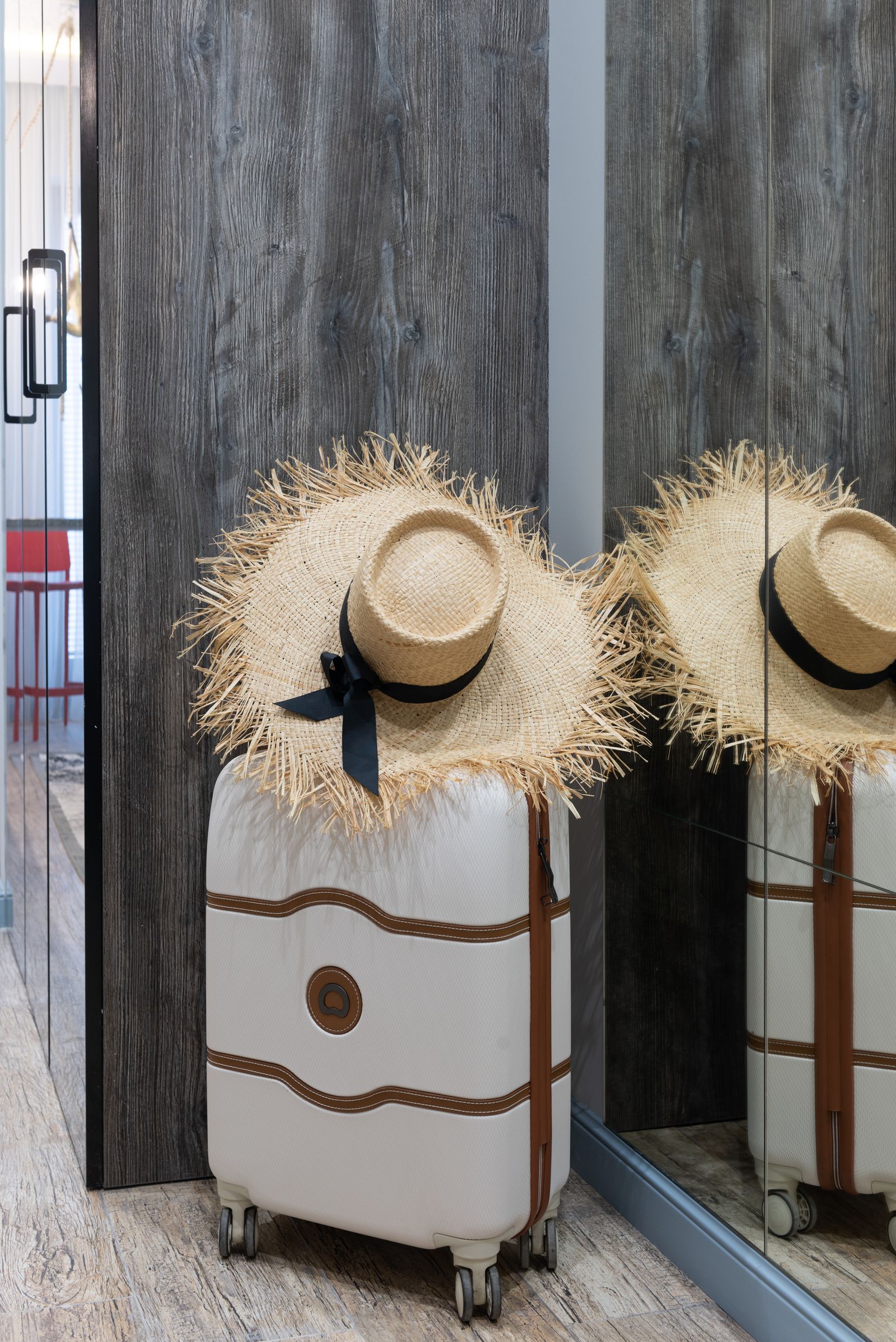 Clean rolling suitcase standing upright in a bright indoor travel setting