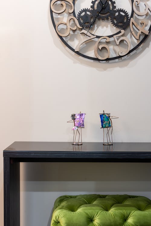 Wooden desk with decorations near wall