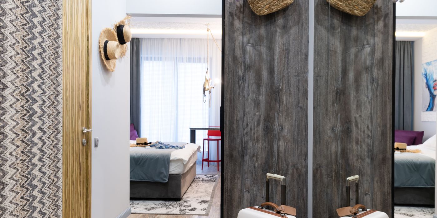 Open suitcase and luggage on the floor of a hotel room before checkout