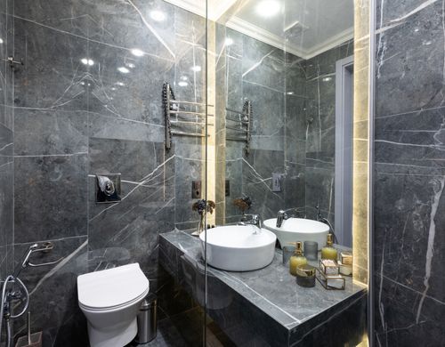 Free Contemporary bathroom with mirror and washbasin near assorted hygiene products and toilet bowl under shiny lamps Stock Photo