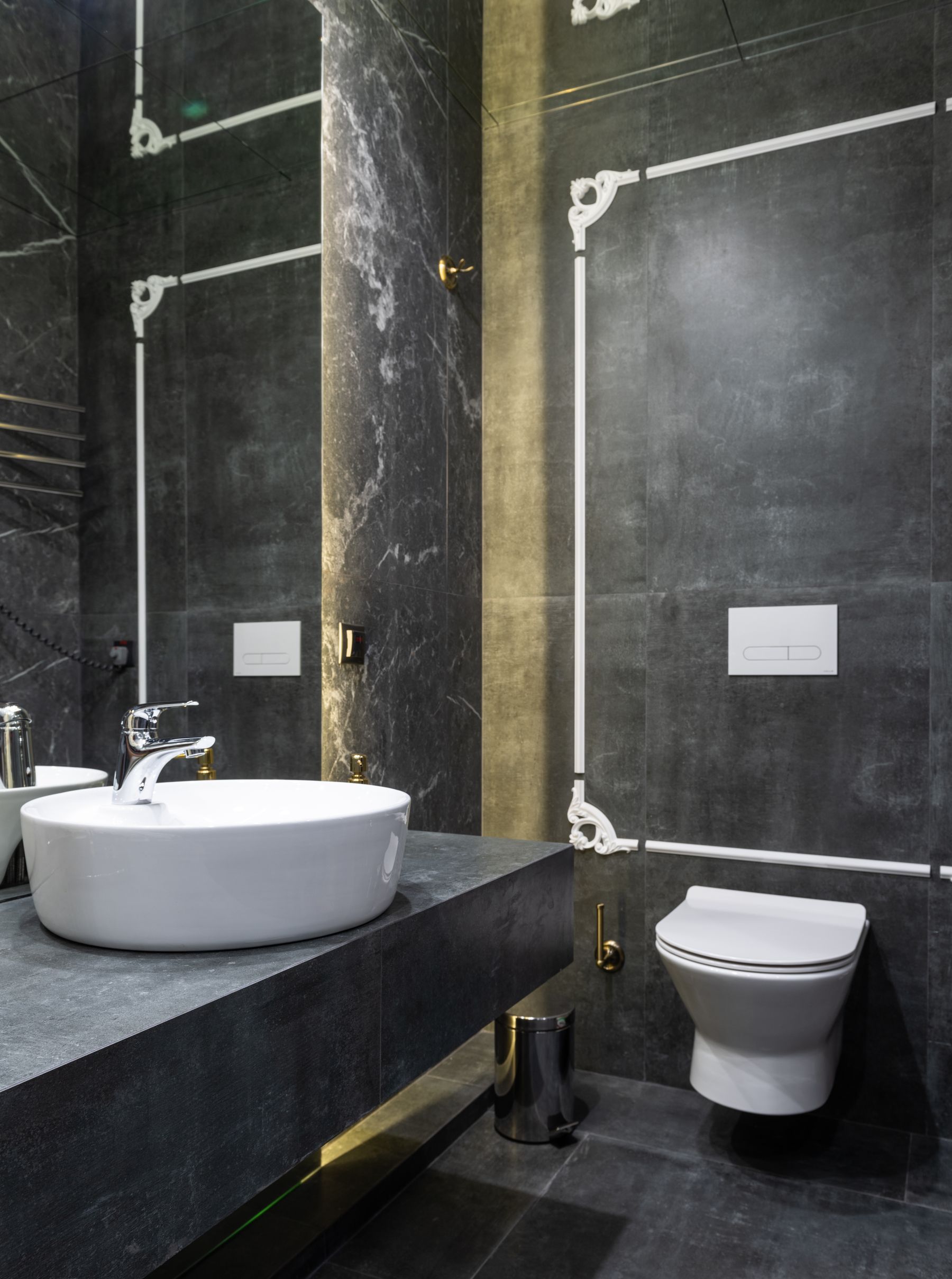 Elegant contemporary dark bathroom with marble and polished surfaces