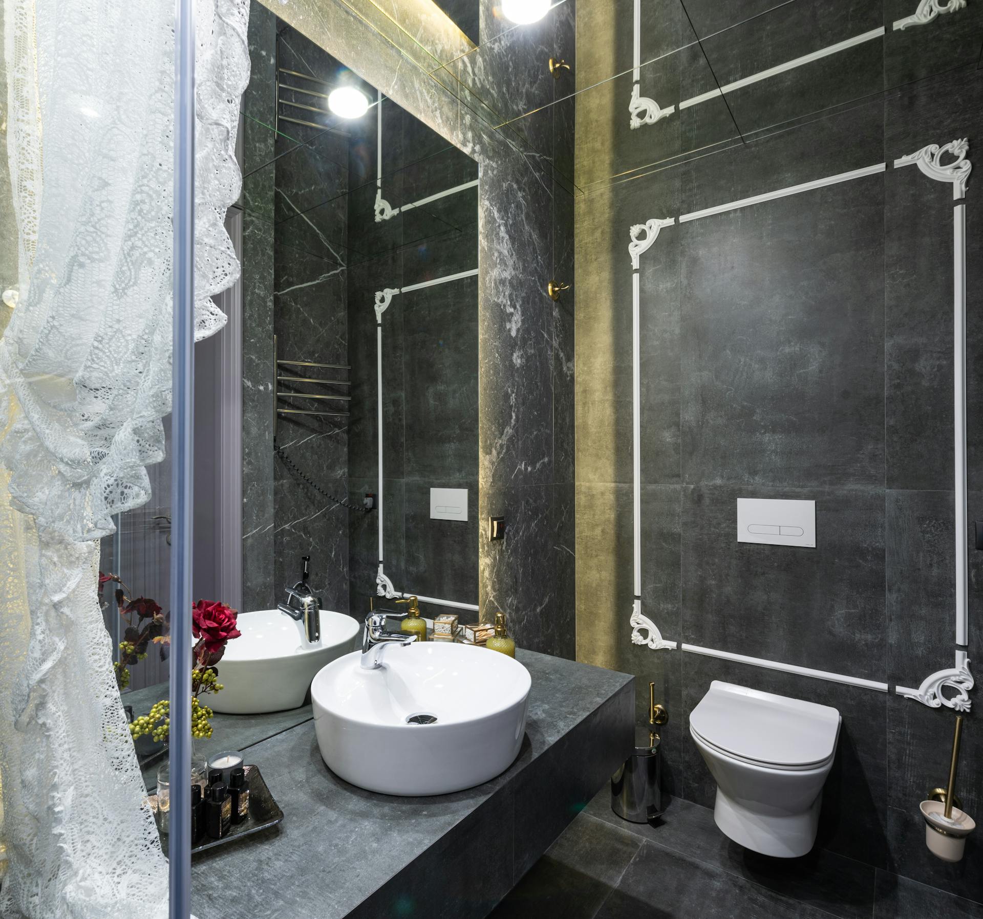 Elegant bathroom with modern fixtures and artistic ceramic tile design.