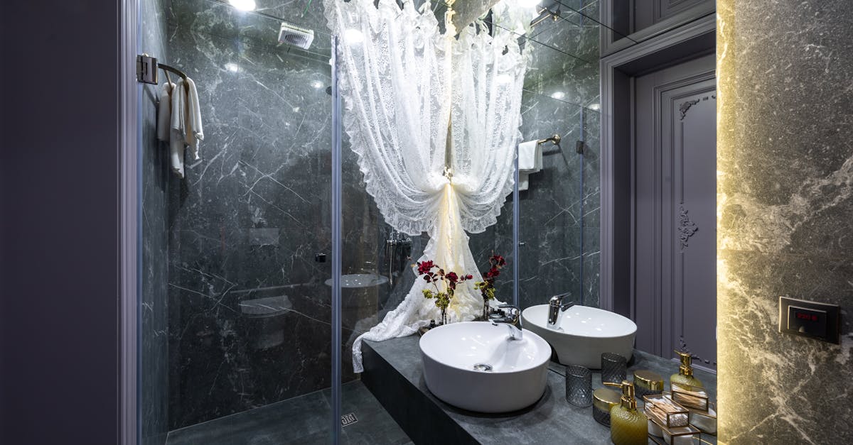 Tulle curtain between shower room and washbasin with various toiletry products reflecting in mirror at home