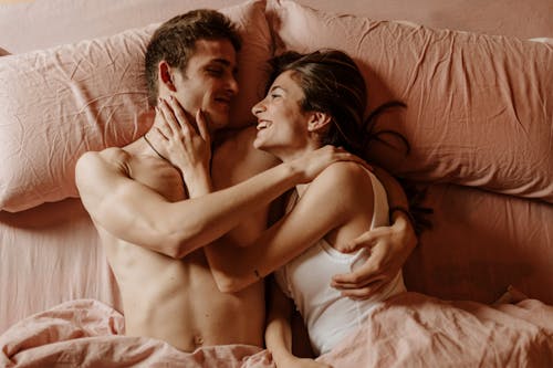 Free Close-Up Shot of a Couple Lying Down on the Bed Together Stock Photo