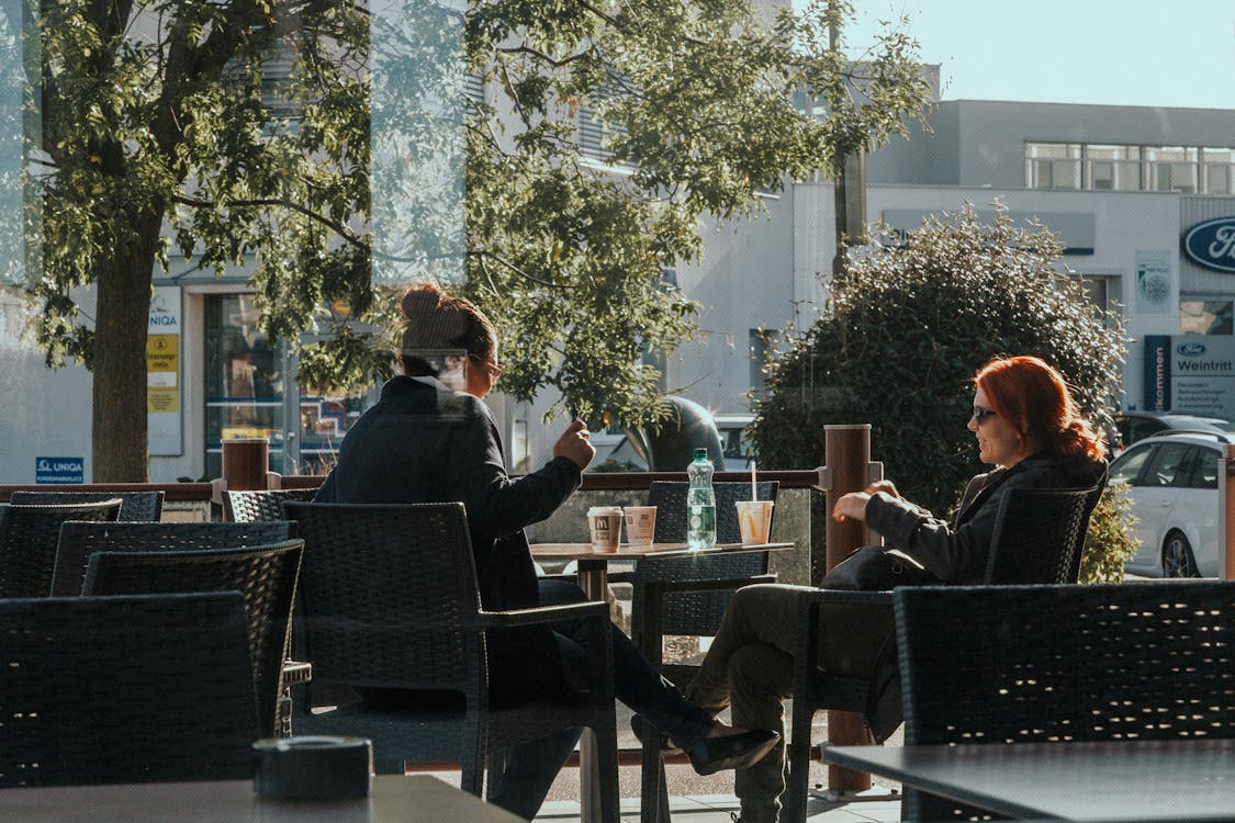 Free Women Sitting at the Table Stock Photo