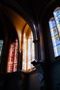 Interior design of historic cathedral dome with colorful leaded glass windows in sunlight