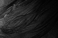 Rough dark sand of shallow river