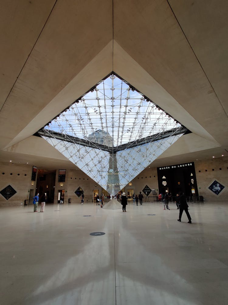 People Walking Inside The Louvre Museum