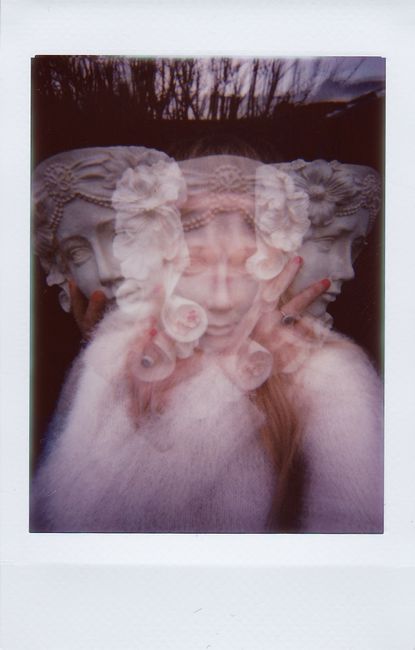 Surreal double exposure of woman and ancient sculpture creates a dreamy effect.