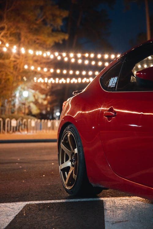 Red Car on the Road during Night Time