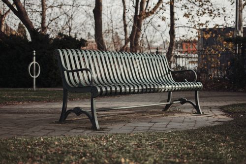 Free Peaceful autumn scene with a solitary park bench in Milton, Ontario. Stock Photo