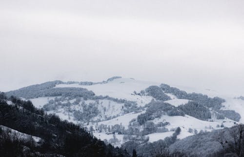 Snowy mountain ridge on cloudy winter day