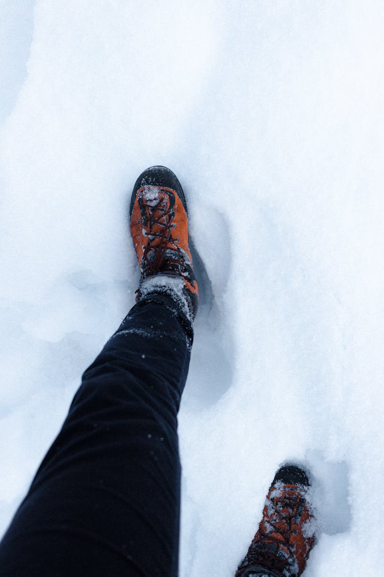 Crop Person Walking On Snowy Ground