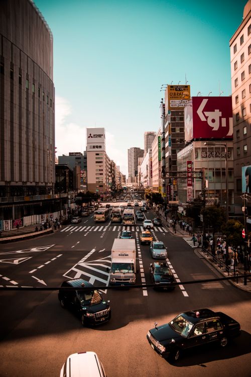 Free Vibrant city life in Japan showcasing traffic and architecture on a busy day. Stock Photo