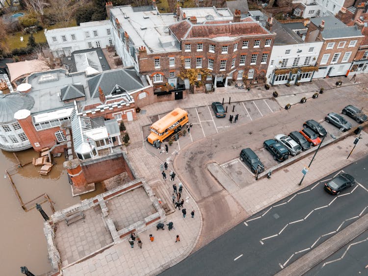 Building Near Road With People And Parking With Vehicles