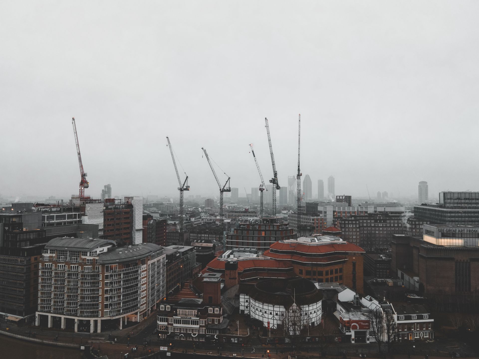 Construction cranes lined up across the London skyline
