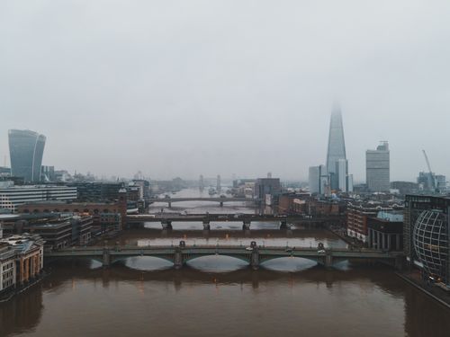 Free Aerial view of London's skyline with The Shard in misty weather, highlighting modern architecture. Stock Photo