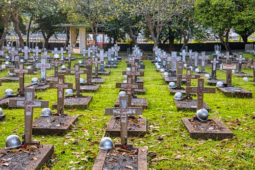 Cemetery with hardhats on military gravestones