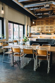A trendy café interior featuring wood decor, industrial elements, and cozy seating arrangements.