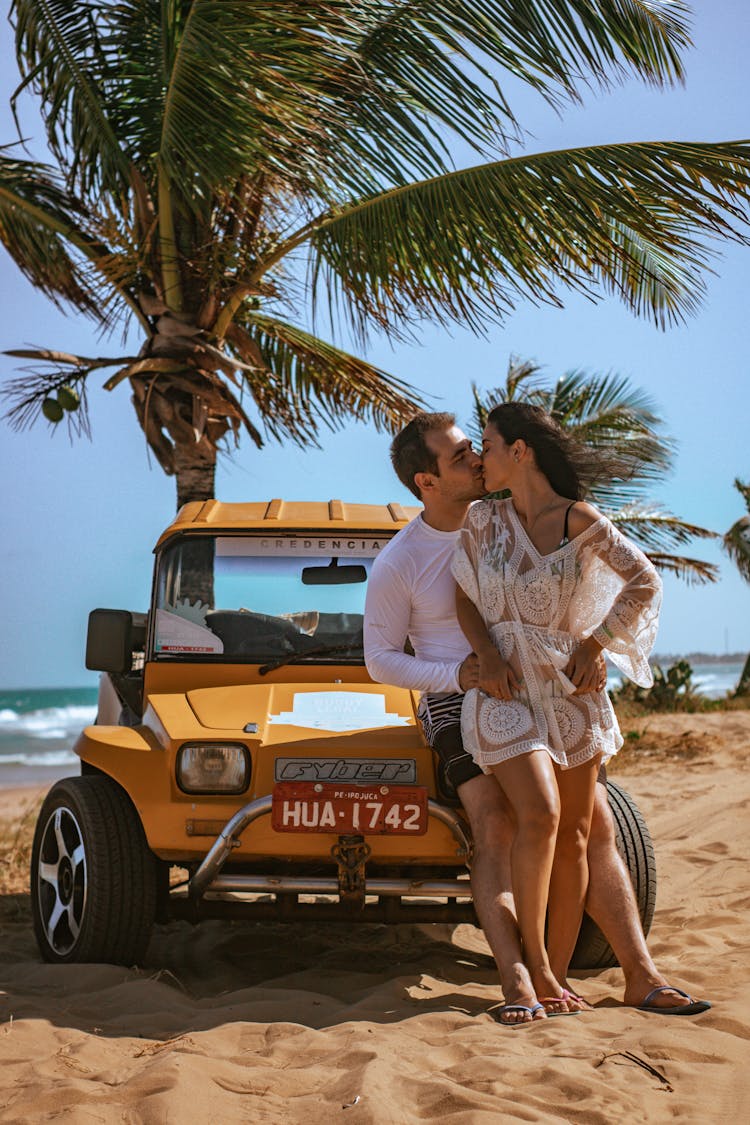 Loving Couple Kissing On Beach Near Car