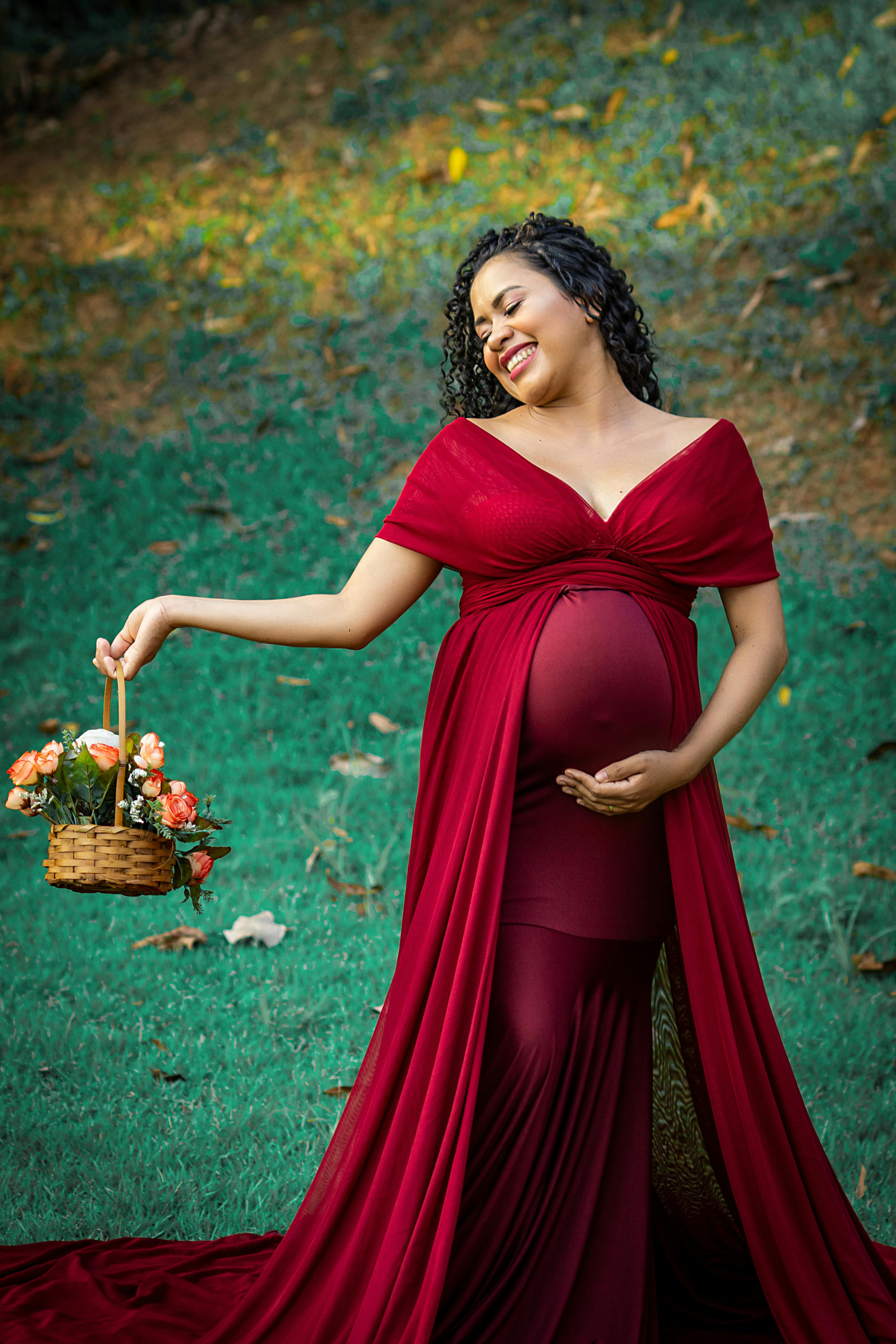 happy black pregnant woman in nature