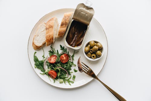 Free A Healthy Meal of  Bread with Anchovies, Olives and Vegetables Stock Photo
