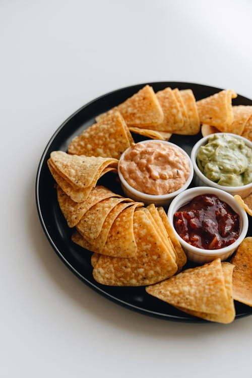 Plate with Nachos and Different Flavor Salsa 