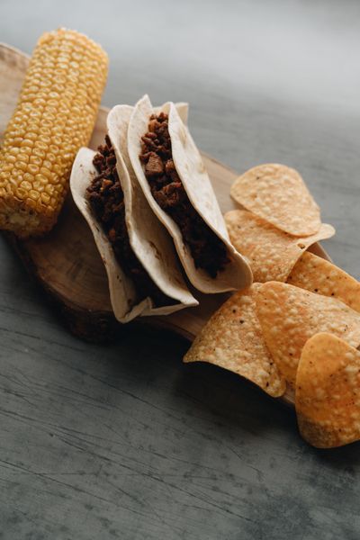 Corn tortilla tacos with fresh garnish — photo by alleksana on Pexels