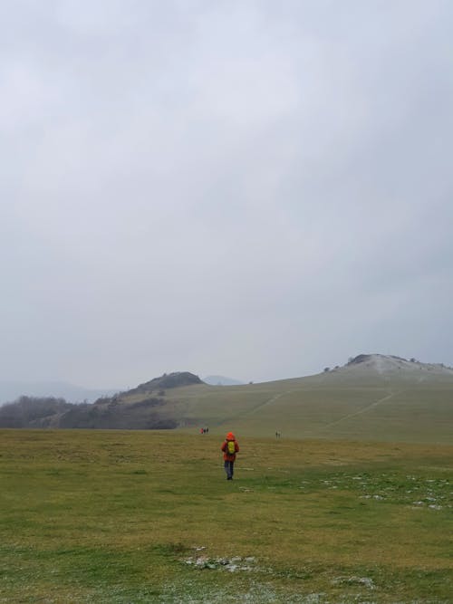 Person Walking Meadow in Mountain Landscape