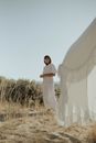 Stylish female standing in nature in daytime