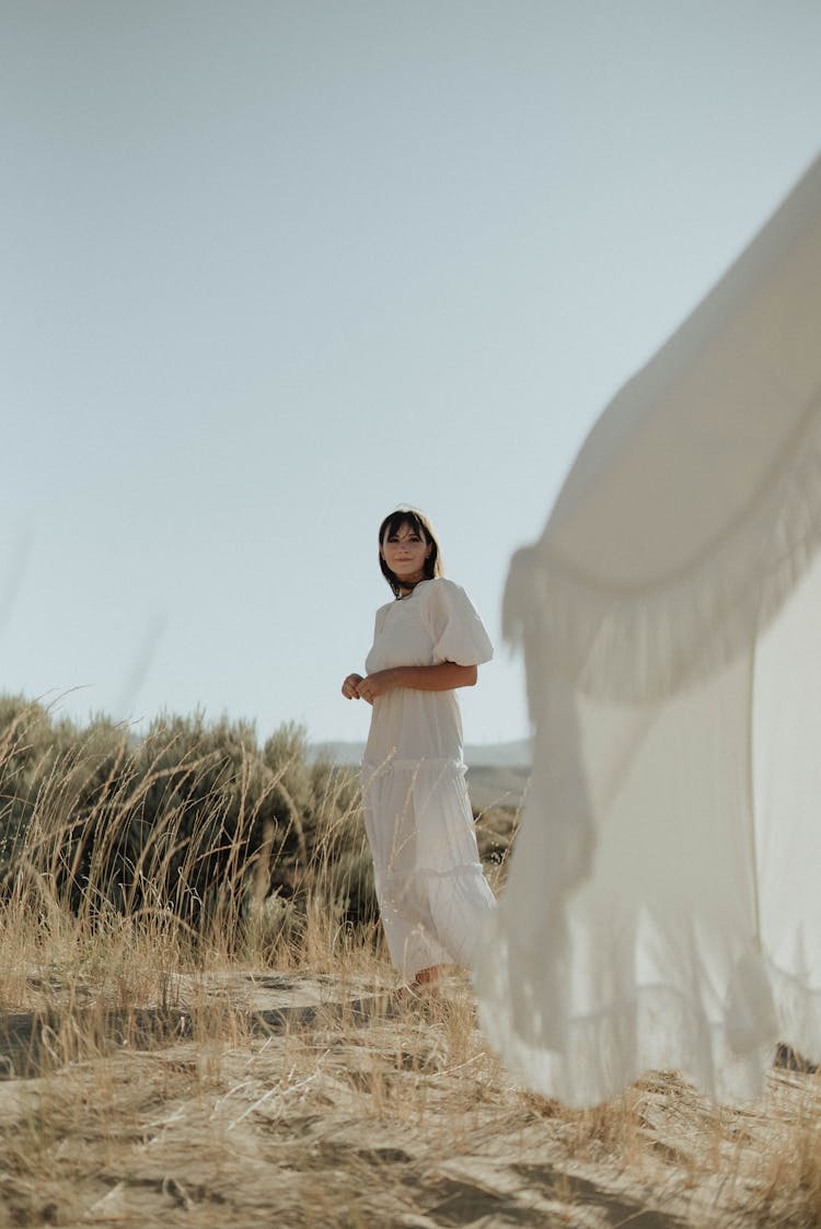 Young Woman Resting In Grassy Field In Summer