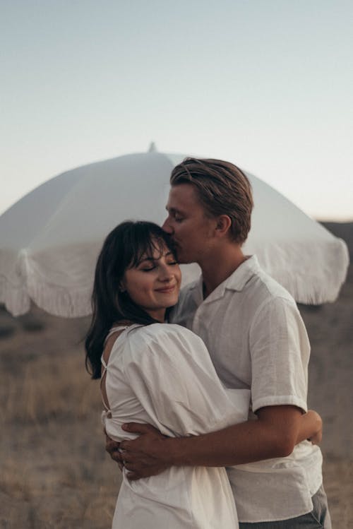 Loving couple hugging in field