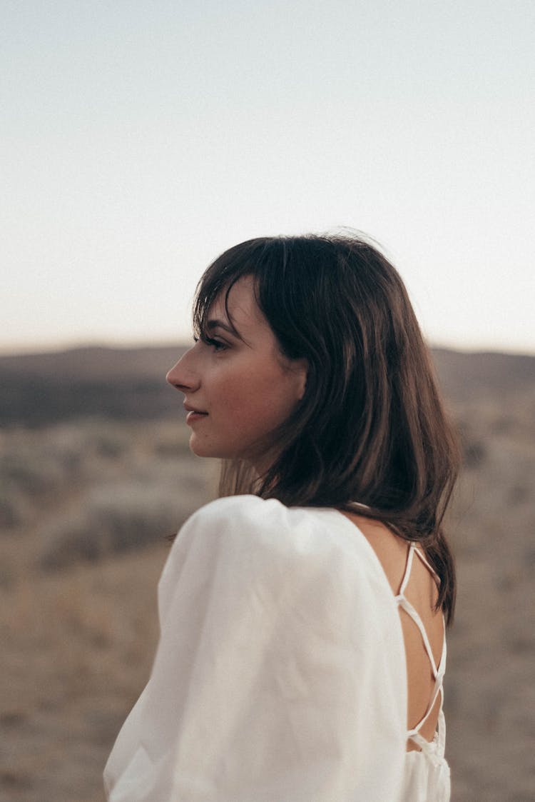 Thoughtful Woman Standing In Field