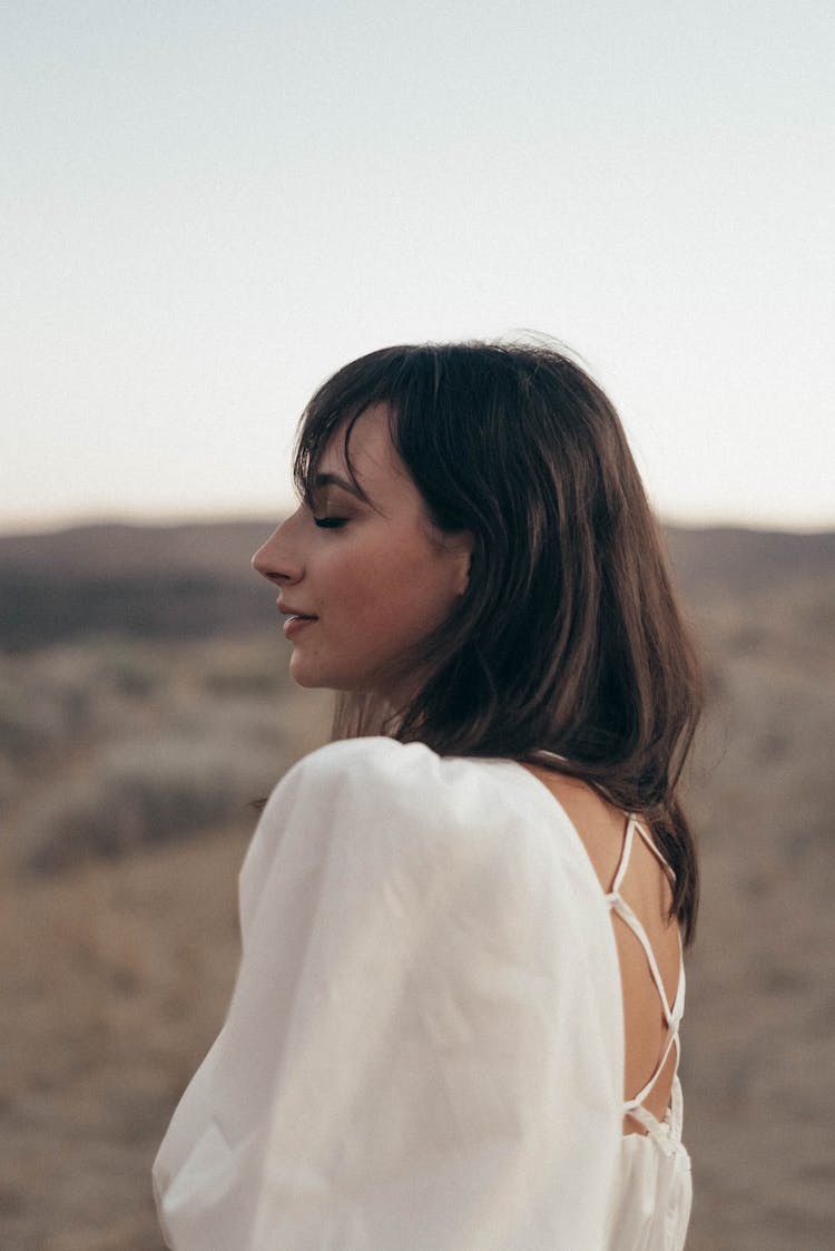 Dreamy Woman In Dress Standing In Field