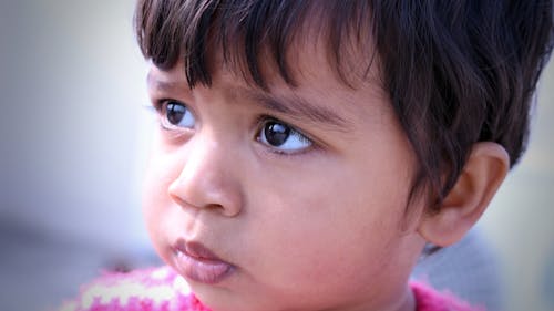 Close-up Shot of a Little Girl Looking Afar