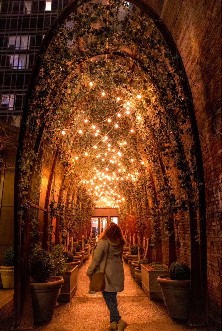 Woman Admiring Entrance To The NoMo Soho Hotel At Night