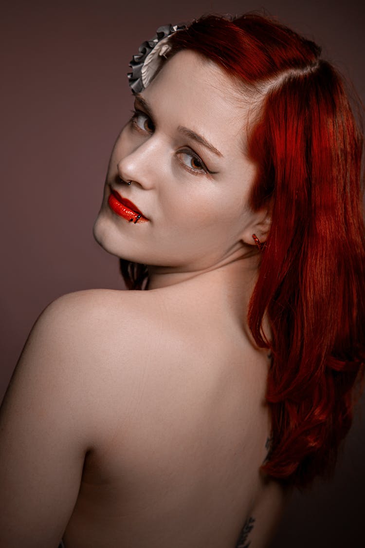 A Redhead Woman Looking Over Her Shoulder