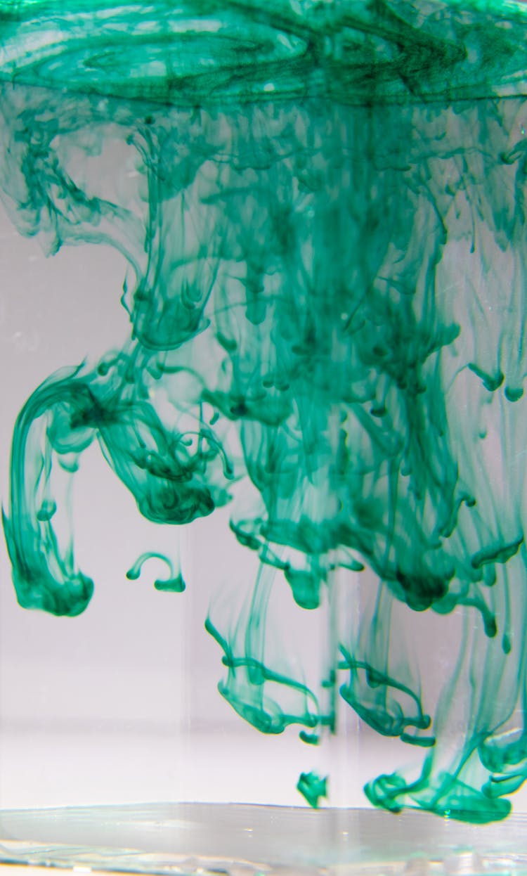 Vase With Green Ink Flows Spreading In Liquid