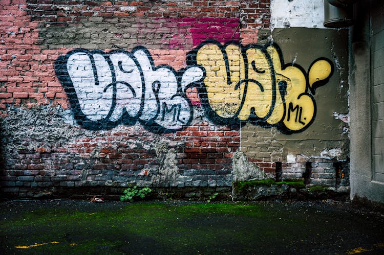 Shabby Brick Wall With Graffiti In Town