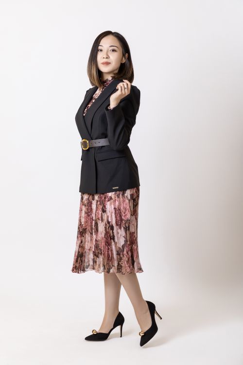 Free Stylish woman in elegant attire posing on a white background. Stock Photo