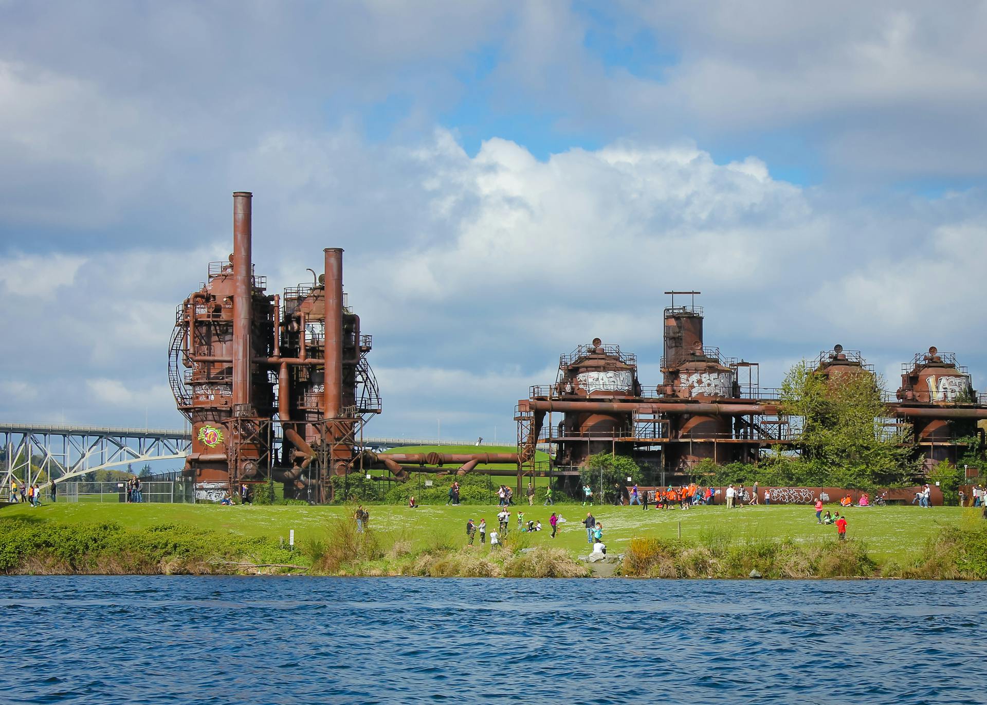 View of Gas Works Park with old industrial structures and visitors enjoying the outdoors.