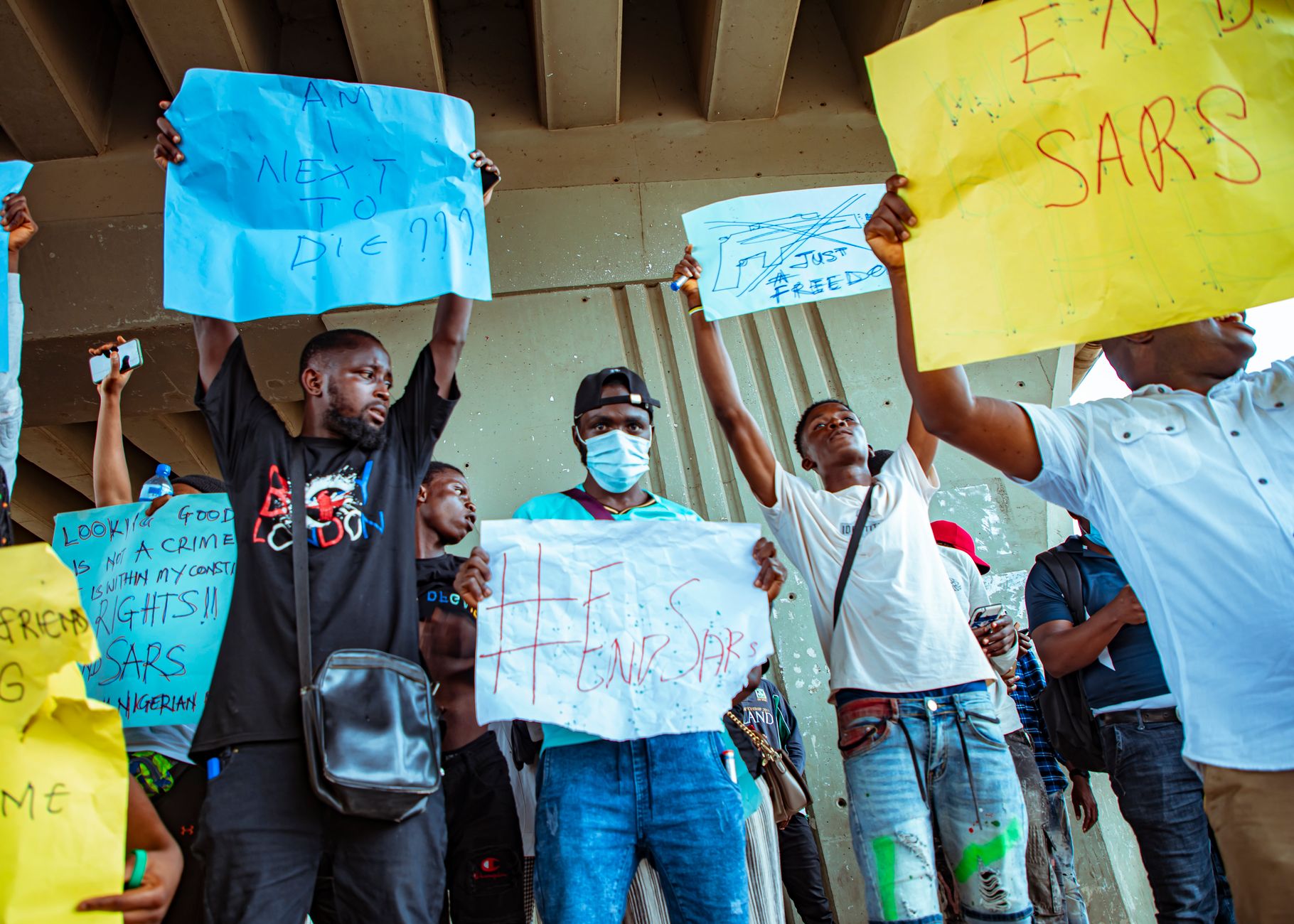 A group of protesters in Nigeria holding signs during an End SARS rally.