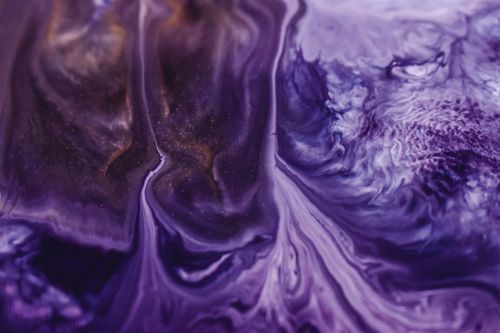 Free Close-up of a vibrant purple marble texture with flowing ink patterns, creating an abstract and artistic design. Stock Photo