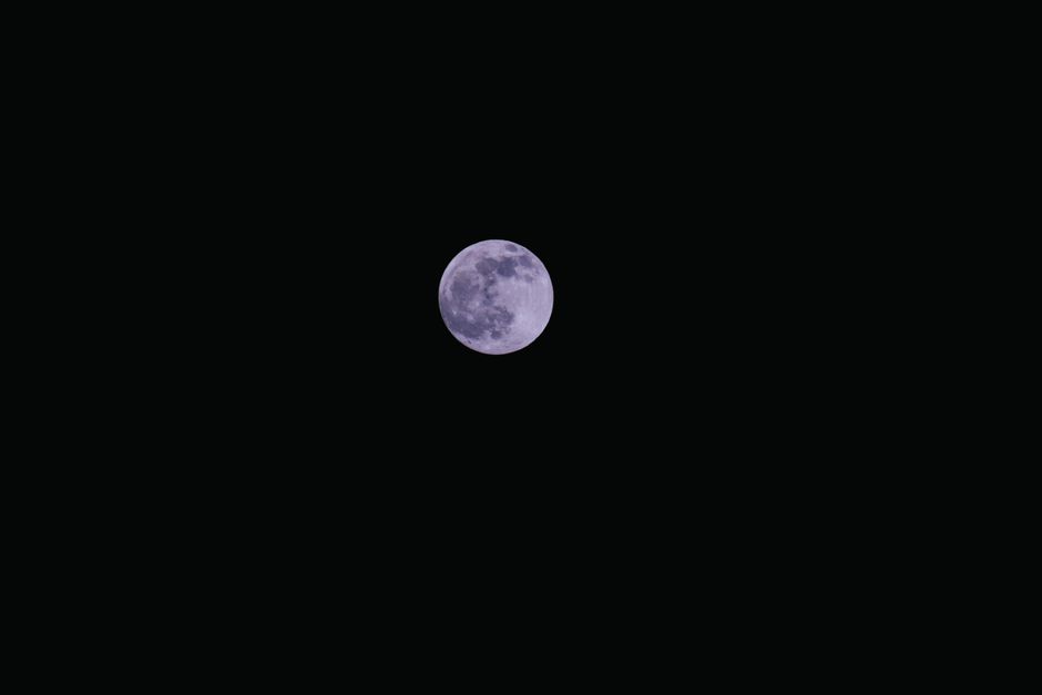 Capture the beauty of a full moon against a dark sky, perfect for night sky enthusiasts.