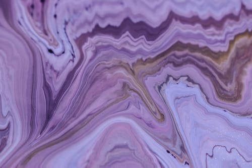 Abstract backdrop representing artwork with violet and brown paint fluids creating rows of wavy lines