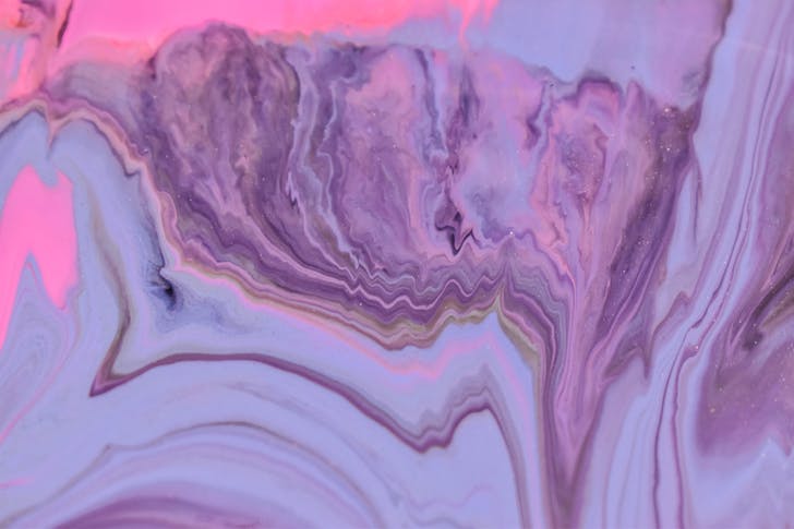 Abstract background of artwork representing pink and purple acrylic paint fluids with thin waves
