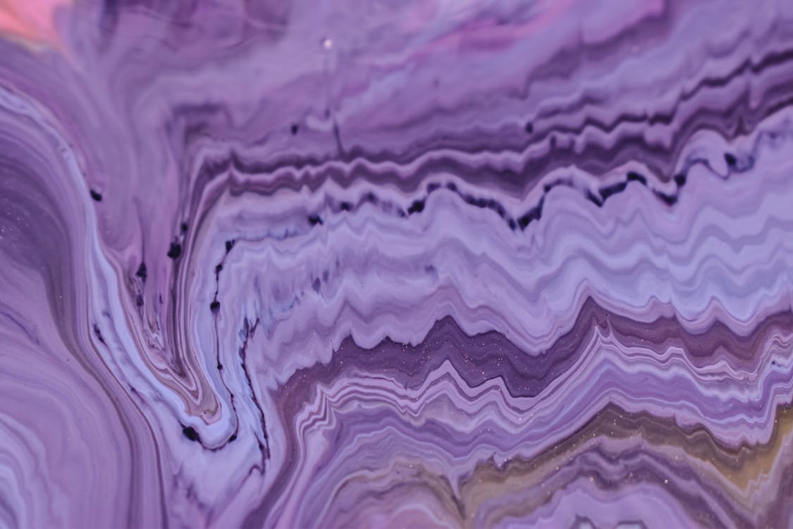 Abstract background of artwork with violet ink fluids
