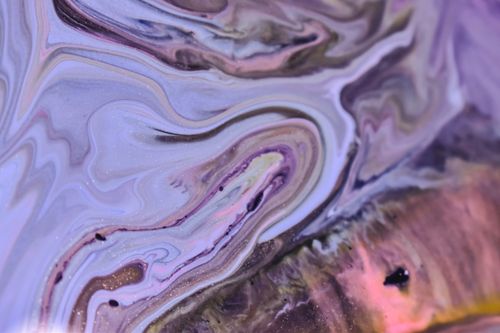 Free Colorful abstract background of spilled glossy blue and purple fluids swirling and diffusing Stock Photo